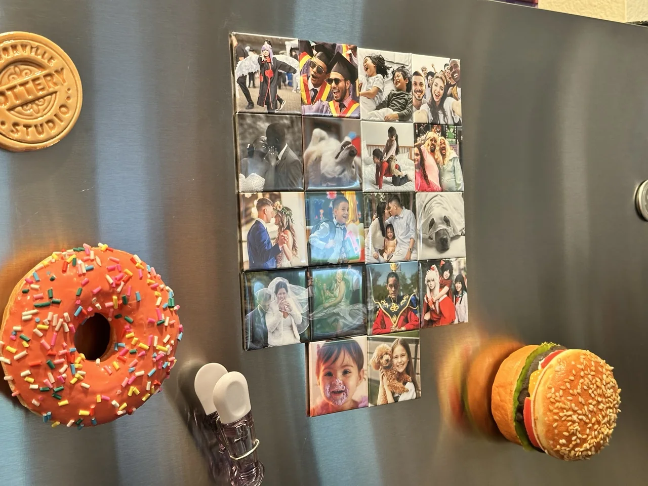 A collection of TAGO photo magnets on a stainless steel refrigerator